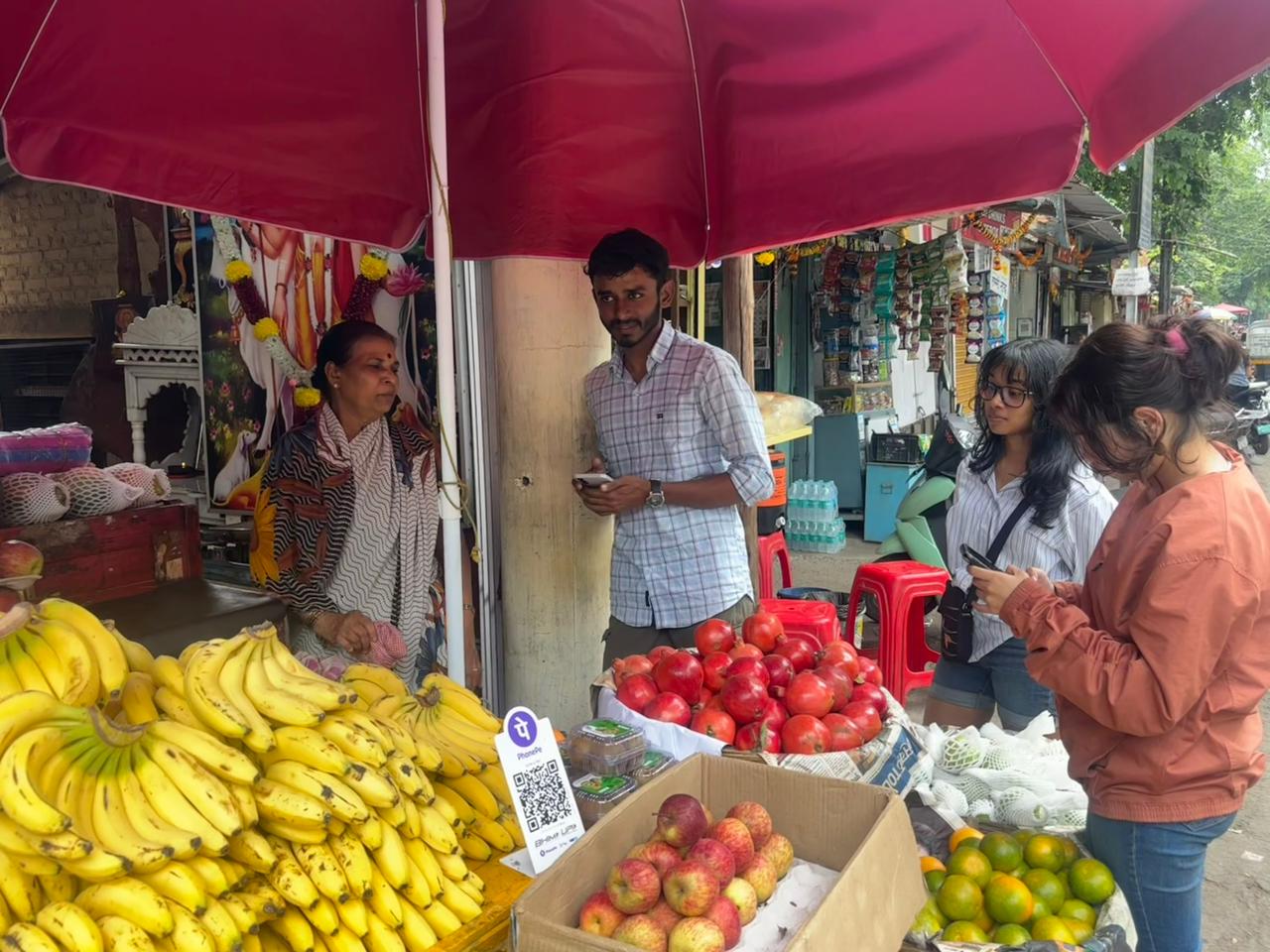 MEER researchers speaking with a fruit vendor in Pune