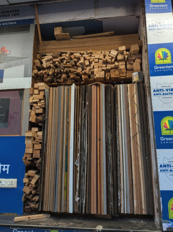 Stacked wooden battens and laminate sheets at a supplier's shop