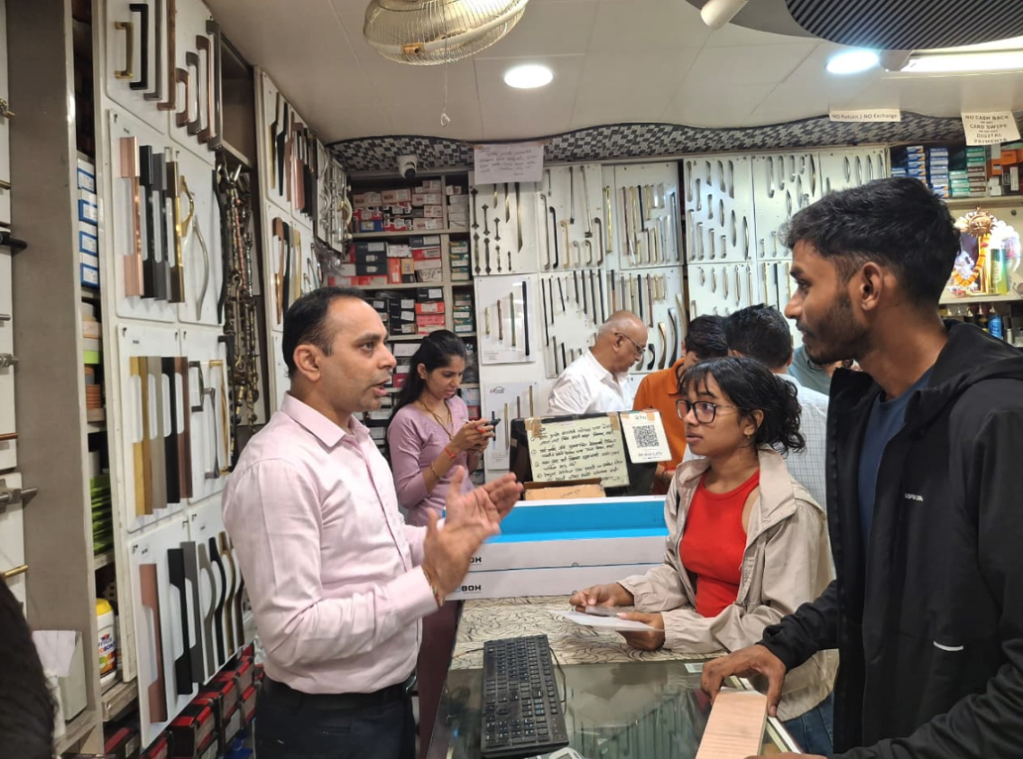 MEER India team members speaking with a hardware supplier at a shop counter